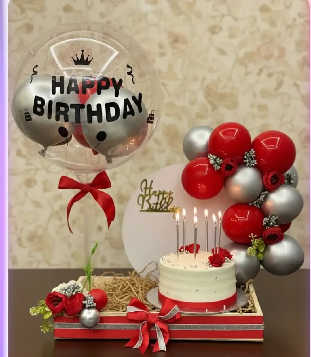 Birthday celebration setup with balloons and flowers